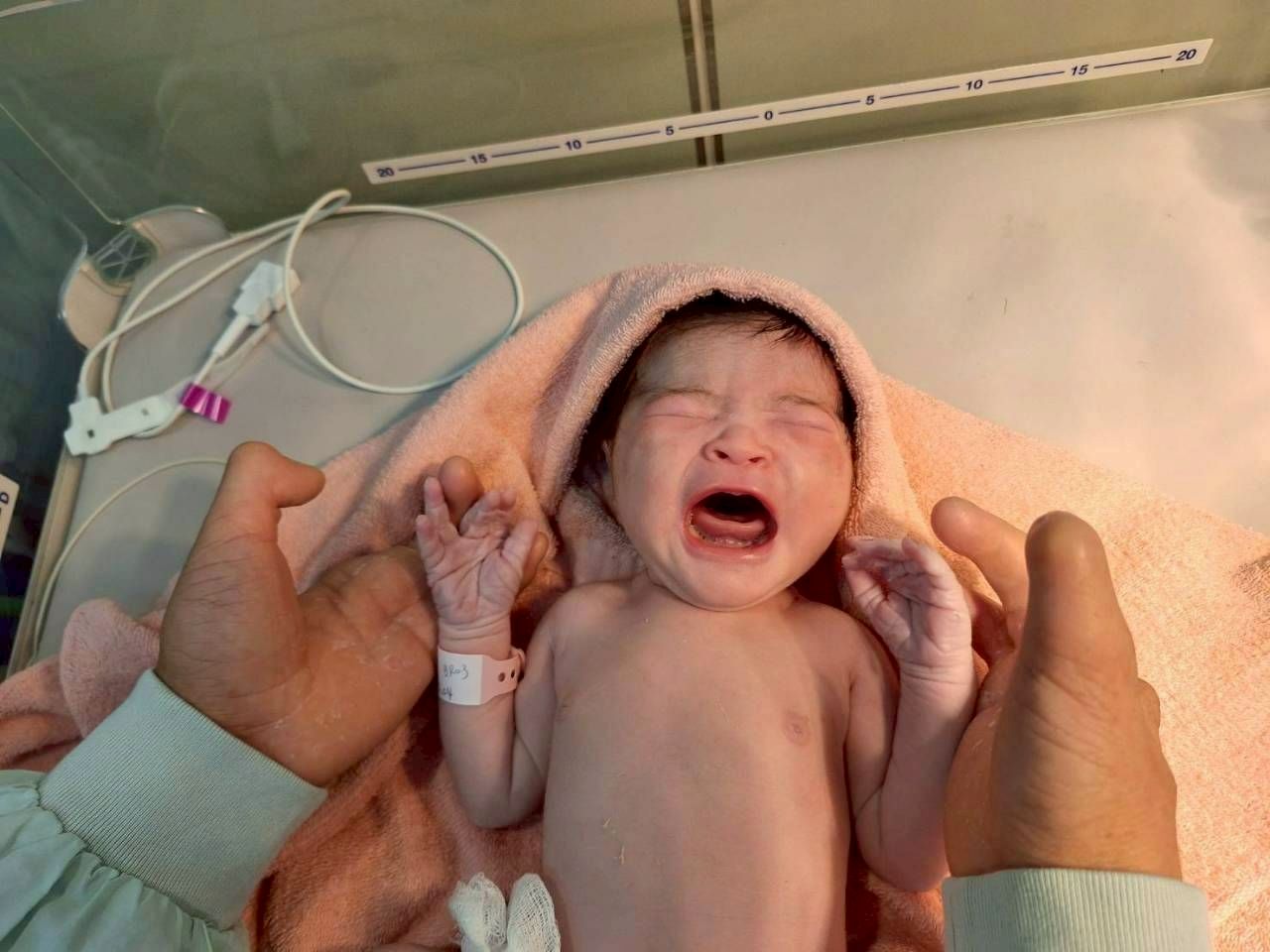 圖為李先生在產房迎接女兒